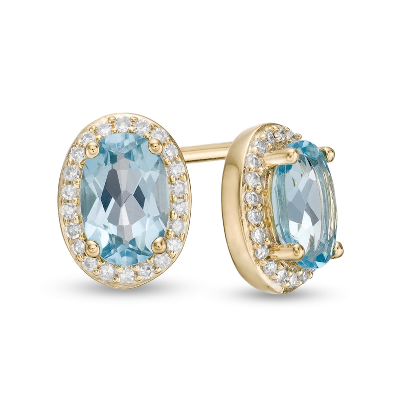 Oval Blue Topaz and 1/10 CT. T.W. Diamond Frame Stud Earrings in 10K Gold