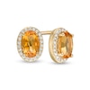 Thumbnail Image 0 of Oval Citrine and 1/10 CT. T.W. Diamond Frame Stud Earrings in 10K Gold