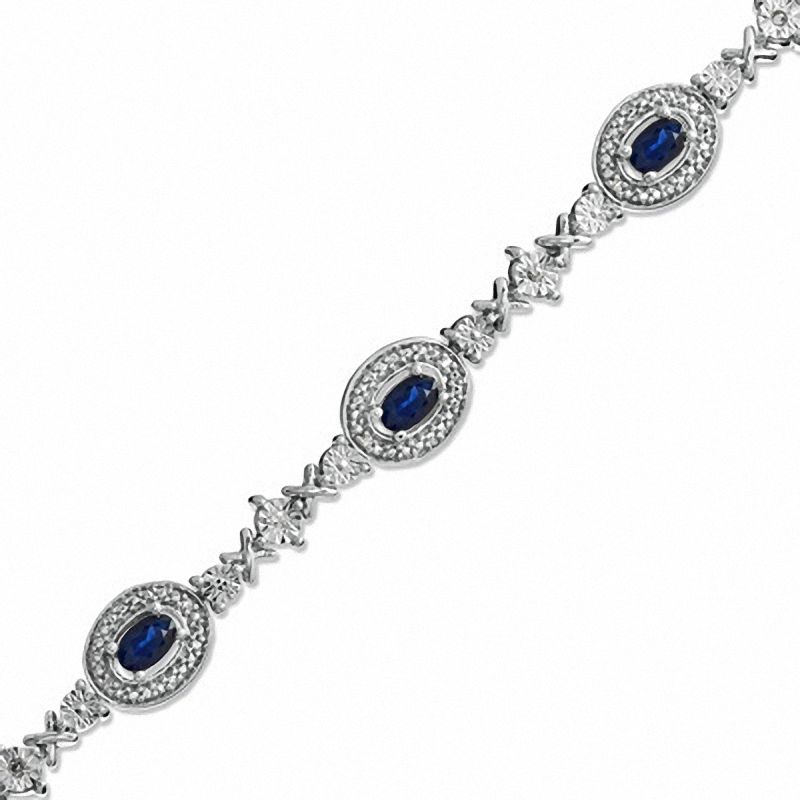 Oval Blue Sapphire and 1/10 CT. T.W. Diamond Bracelet in Sterling Silver