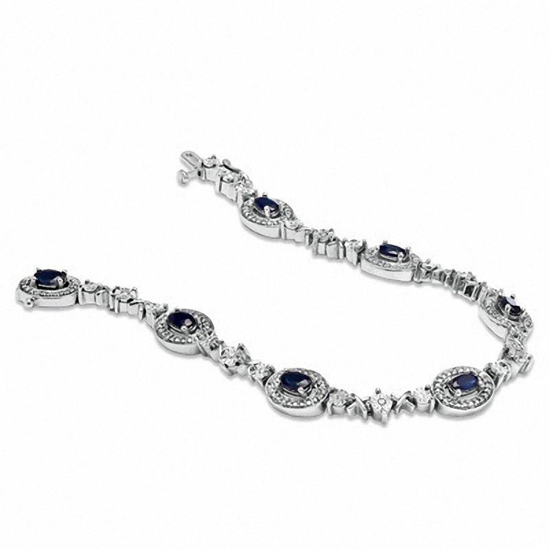 Oval Blue Sapphire and 1/10 CT. T.W. Diamond Bracelet in Sterling Silver