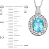 Thumbnail Image 1 of Oval Blue Topaz and Lab-Created White Sapphire Pendant in 10K White Gold