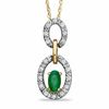 Oval Emerald and 1/8 CT. T.W. Diamond Double Circle Frame Pendant in 10K Gold