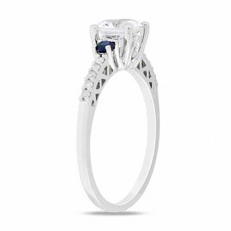 Main Image 2 of Lab-Created White and Blue Sapphire Three Stone Ring with 1/10 CT. T.W Diamonds in 10K White Gold