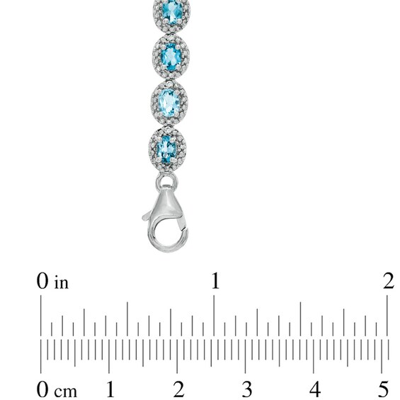 Oval Blue Topaz and 1/20 CT. T.w. Diamond Bracelet in Sterling Silver - 7.5"