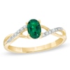Thumbnail Image 1 of Oval Lab-Created Emerald and Diamond Accent Twist Engagement Ring in 10K Gold