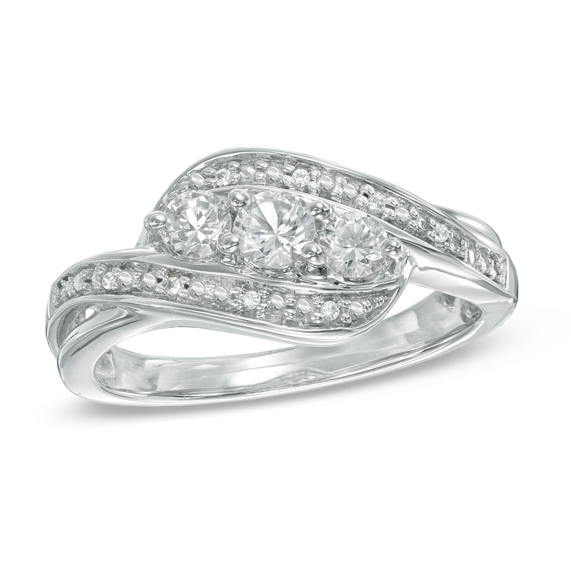 Lab-Created White Sapphire and Diamond Accent Three Stone Ribbon Promise Ring in Sterling Silver