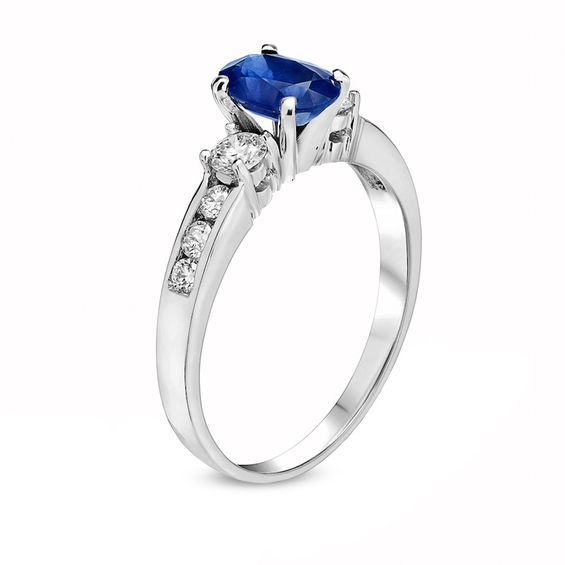 Oval Blue Sapphire and 3/8 CT. T.W. Diamond Three Stone Ring in 14K