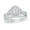 Thumbnail Image 0 of Celebration Ideal 1-1/5 CT. T.W. Diamond Layered Oval Frame Crossover Bridal Set in 14K White Gold (I/I1)