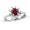 Thumbnail Image 0 of Oval Ruby and 1/6 CT. T.W. Diamond Sunburst Frame Ring in 14K White Gold