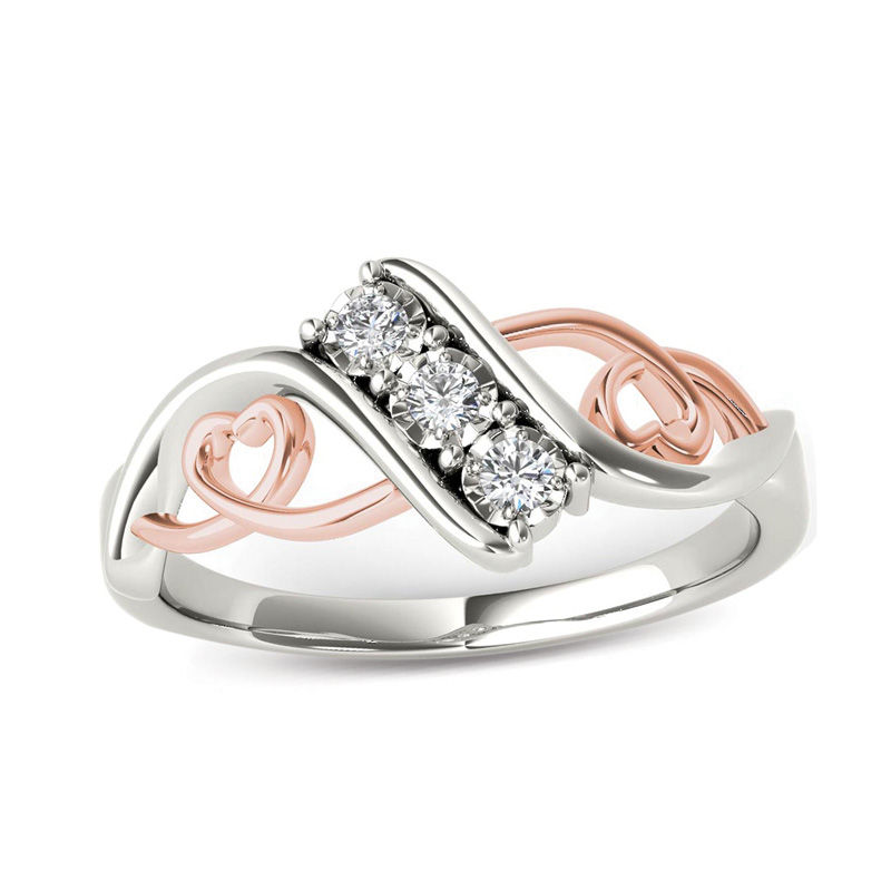 1/10 CT. T.W. Diamond Three Stone Bypass with Hearts Ring in 14K White Gold and Rose Rhodium