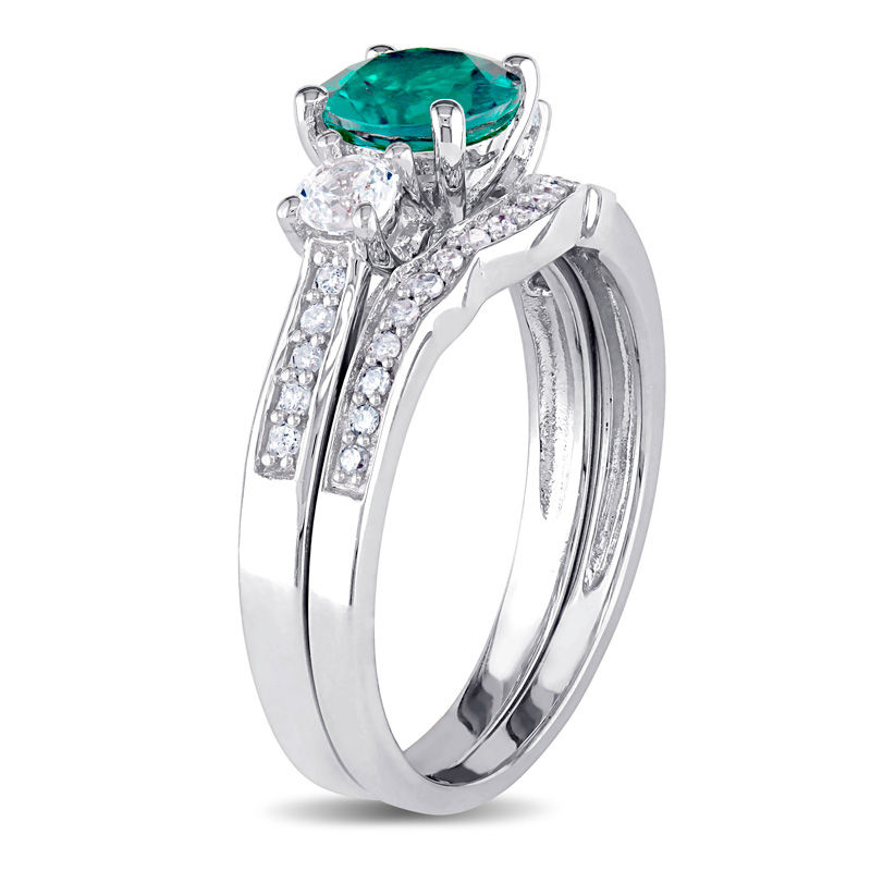 6.0mm Lab-Created Emerald and White Sapphire with 1/8 CT. T.W. Diamond Three Stone Bridal Set in 10K White Gold