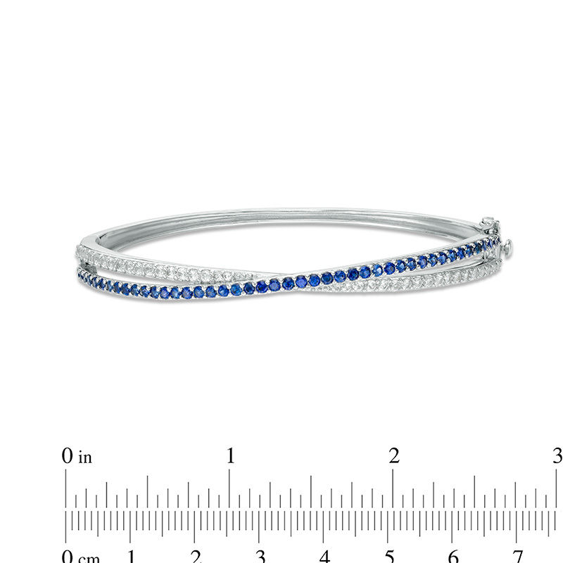 Lab-Created Blue and White Sapphire Crossover Ribbon Bangle in Sterling Silver