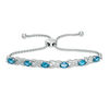 Thumbnail Image 1 of Oval Swiss Blue Topaz and Diamond Accent "XO" Bolo Bracelet in Sterling Silver - 9.5"