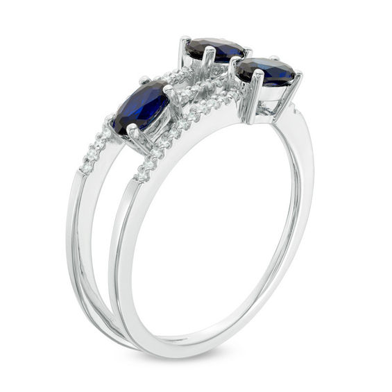 Oval Blue Sapphire and 1/10 CT. T.w. Diamond Three Stone Wrap Ring in 10K White Gold