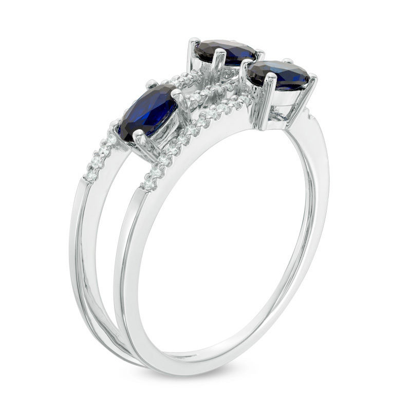 Oval Blue Sapphire and 1/10 CT. T.W. Diamond Three Stone Wrap Ring in 10K White Gold