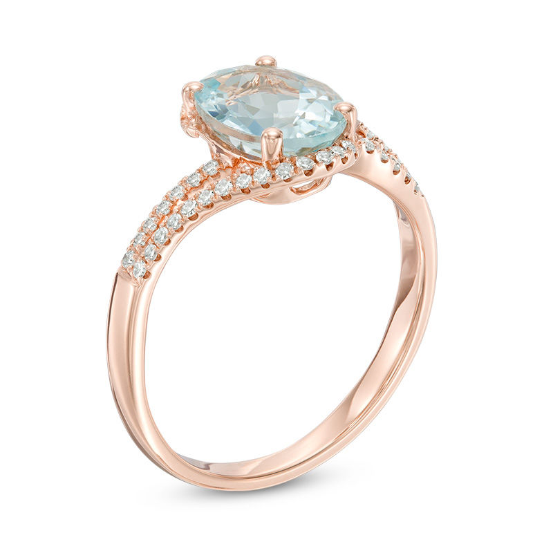 Oval Aquamarine and 1/8 CT. T.W. Diamond Bypass Split Shank Ring in 10K Rose Gold