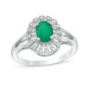 Thumbnail Image 1 of Oval Emerald and 1/10 CT. T.W. Diamond Frame Split Shank Ring in 10K White Gold