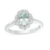 Thumbnail Image 0 of Oval Aquamarine and 1/10 CT. T.W. Diamond Flower Frame Ring in 10K White Gold