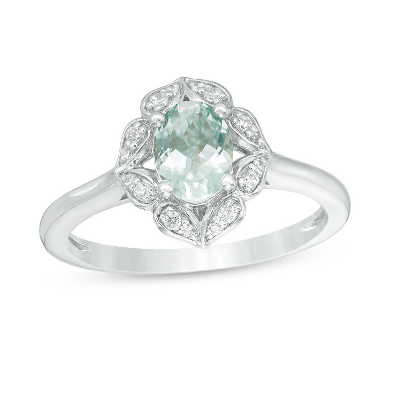 Oval Aquamarine and 1/10 CT. T.W. Diamond Flower Frame Ring in 10K White Gold