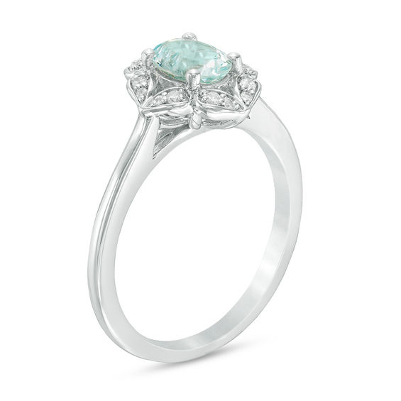 Oval Aquamarine and 1/10 CT. T.w. Diamond Flower Frame Ring in 10K White Gold