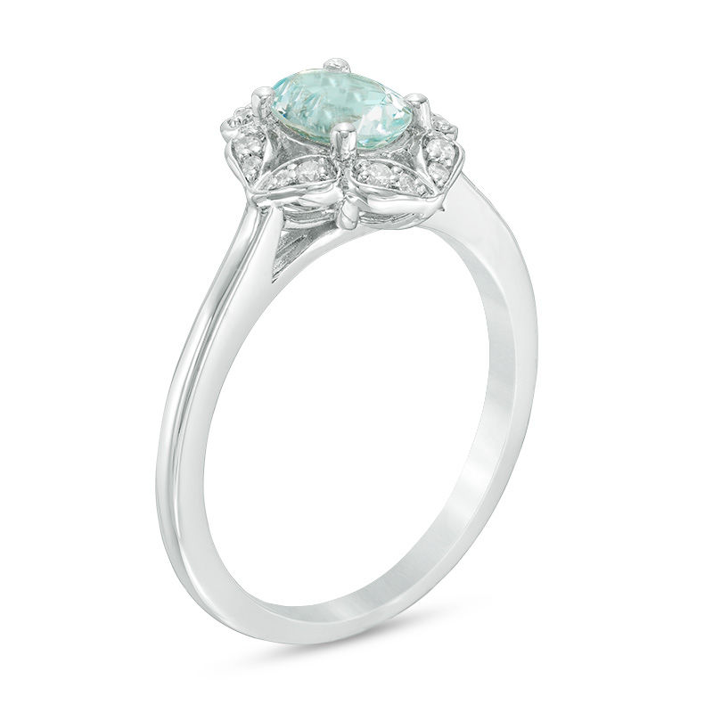 Oval Aquamarine and 1/10 CT. T.W. Diamond Flower Frame Ring in 10K White Gold