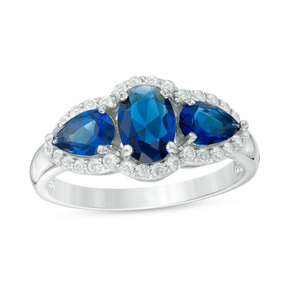 Oval and Pear-Shaped Lab-Created Blue Sapphire with White Topaz Frame Three Stone Ring in Sterling Silver Oval and Pear-Shaped Lab-Created Blue Sapphire with White Topaz Frame Three Stone Ring in Sterling Silver