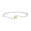 Thumbnail Image 0 of Oval Peridot and Diamond Accent Bypass Bangle in Sterling Silver