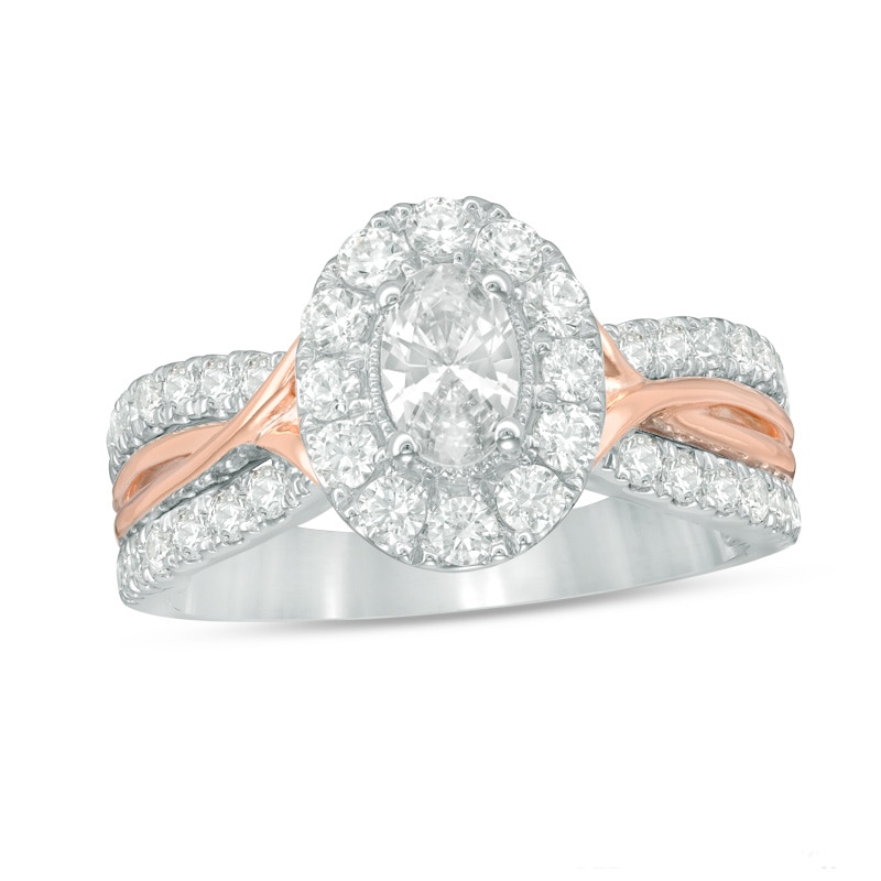 Celebration Ideal 1-1/5 CT. T.W. Oval Diamond Frame Twist Engagement Ring in 14K Two-Toned Gold (I/I1)