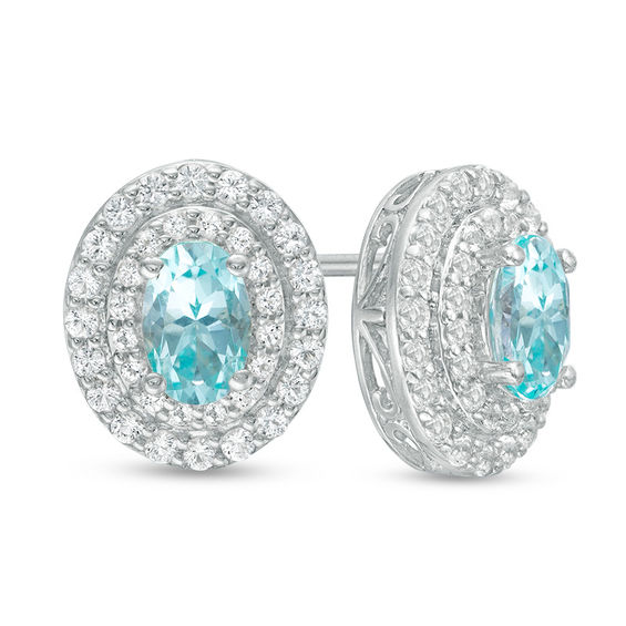 Oval Blue and White Topaz Frame Stud Earrings in Sterling Silver