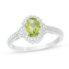 Thumbnail Image 0 of Oval Peridot and 1/8 CT. T.W. Diamond Frame Vintage-Style Ring in 10K White Gold