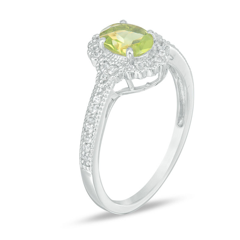 Oval Peridot and 1/8 CT. T.W. Diamond Frame Vintage-Style Ring in 10K White Gold