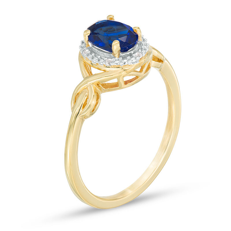 Main Image 2 of Oval Lab-Created Blue Sapphire and Diamond Accent Twist Ring in 10K Gold