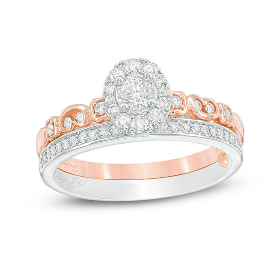 1/2 CT. T.w. Diamond Oval Frame Interlocking Bridal Set in 10K Two-Tone Gold