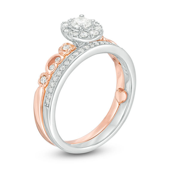 1/2 CT. T.w. Diamond Oval Frame Interlocking Bridal Set in 10K Two-Tone Gold