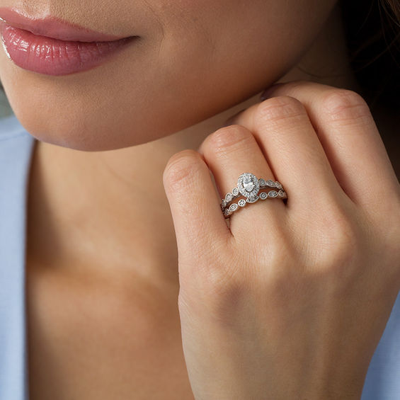 1/2 CT. T.w. Oval Diamond Frame Bridal Set in 14K Gold