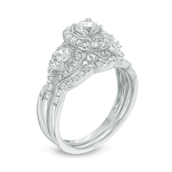 1-1/6 CT. T.w. Diamond Three Stone Oval Frame Twist Bridal Set in 14K White Gold