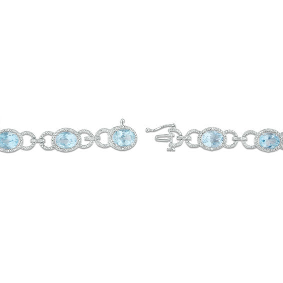 Oval Sky Blue Topaz and 1/20 CT. T.W. Diamond Beaded Buckle Bracelet in Sterling Silver - 7.5" Oval Sky Blue Topaz and 1/20 CT. T.W. Diamond Beaded Buckle Bracelet in Sterling Silver - 7.5"
