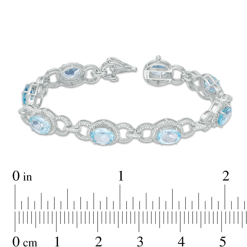 Oval Sky Blue Topaz and 1/20 CT. T.W. Diamond Beaded Buckle Bracelet in Sterling Silver - 7.5"