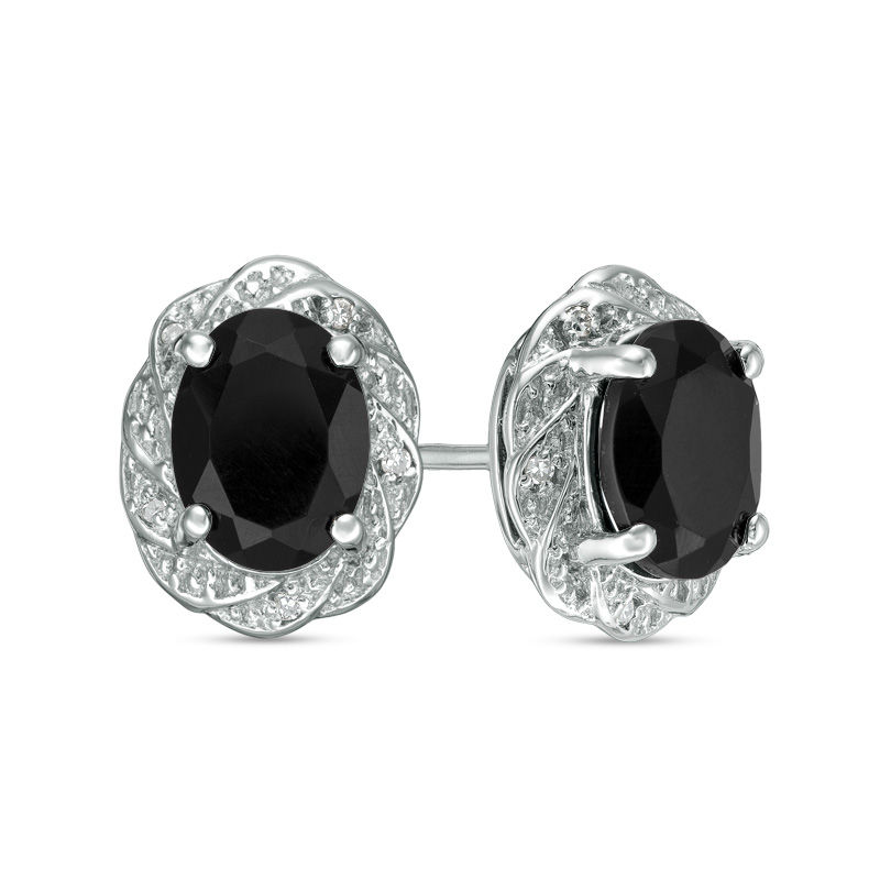 Oval Onyx and 1/20 CT. T.W. Diamond Pinwheel Frame Stud Earrings in Sterling Silver