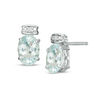 Thumbnail Image 0 of Oval Blue Topaz and Diamond Accent Stud Earrings in Sterling Silver