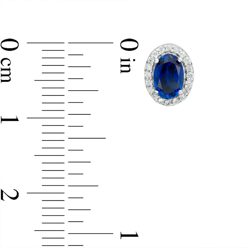 Main Image 2 of Oval Lab-Created Blue Sapphire and 1/8 CT. T.W. Diamond Frame Stud Earrings in 10K White Gold