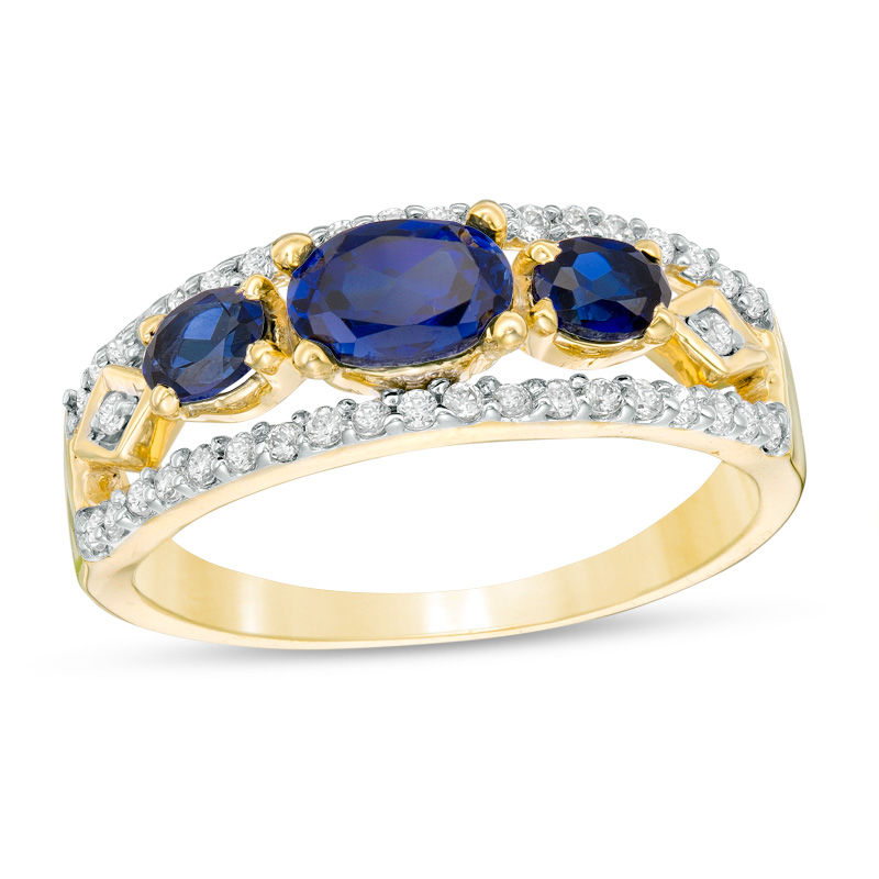 Main Image 1 of Sideways Oval Lab-Created Blue Sapphire and 1/4 CT. T.W. Diamond Three Stone Ring in 10K Gold