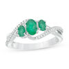 Thumbnail Image 0 of Oval Emerald and 1/10 CT. T.W. Diamond Three Stone Crossover Bypass Ring in 10K White Gold