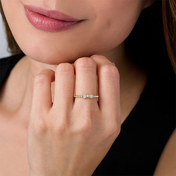 1/20 CT. T.w. Diamond Bow Beaded Shank Ring in 10K Gold