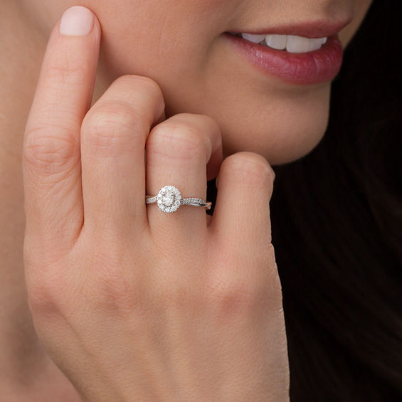 3/8 CT. T.w. Oval Diamond Frame Twist Engagement Ring in 10K White Gold