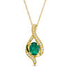 Thumbnail Image 0 of Oval Lab-Created Emerald and White Sapphire Flame Pendant in 10K Gold