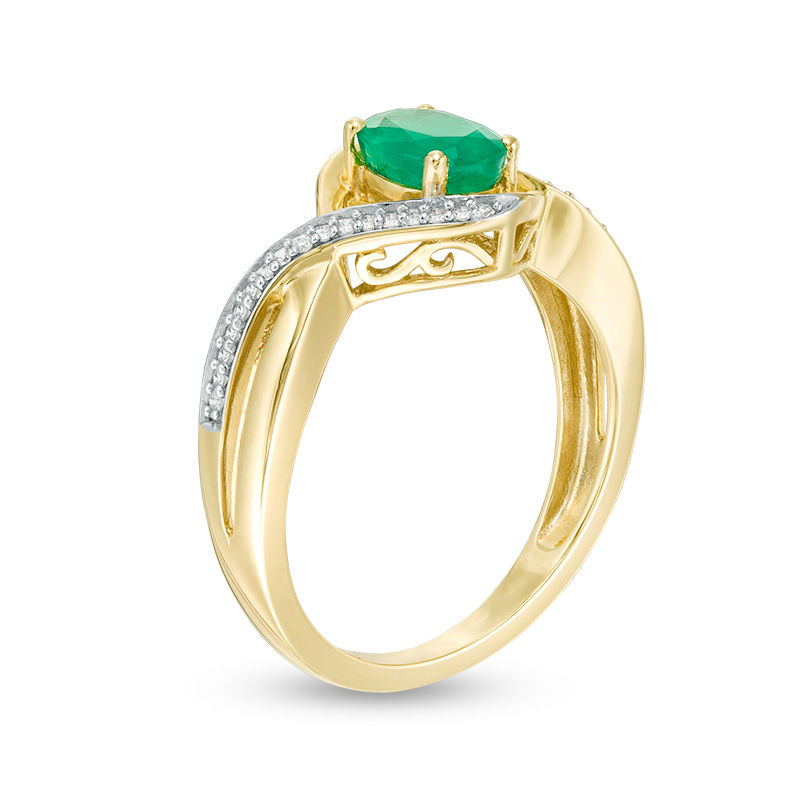 Main Image 2 of Oval Emerald and 1/10 CT. T.W. Diamond Swirl Frame Bypass Ring in 10K Gold