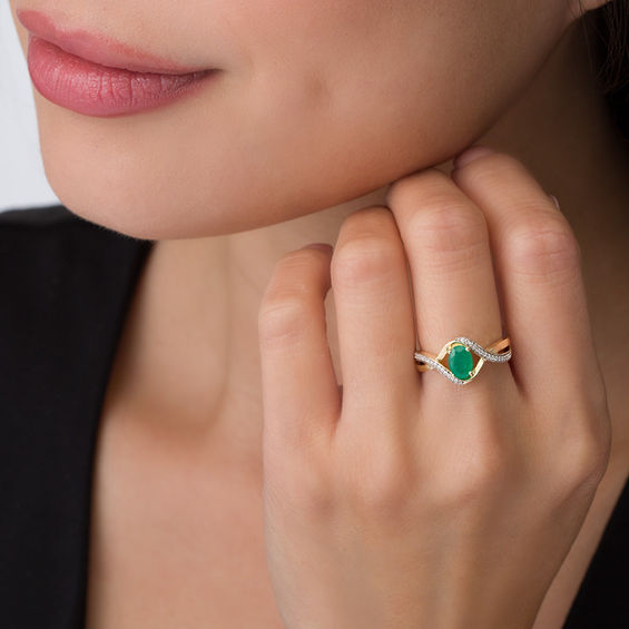 Oval Emerald and 1/10 CT. T.w. Diamond Swirl Frame Bypass Ring in 10K Gold