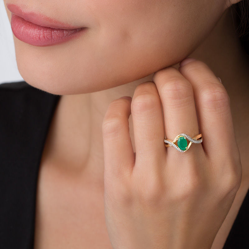 Main Image 3 of Oval Emerald and 1/10 CT. T.W. Diamond Swirl Frame Bypass Ring in 10K Gold