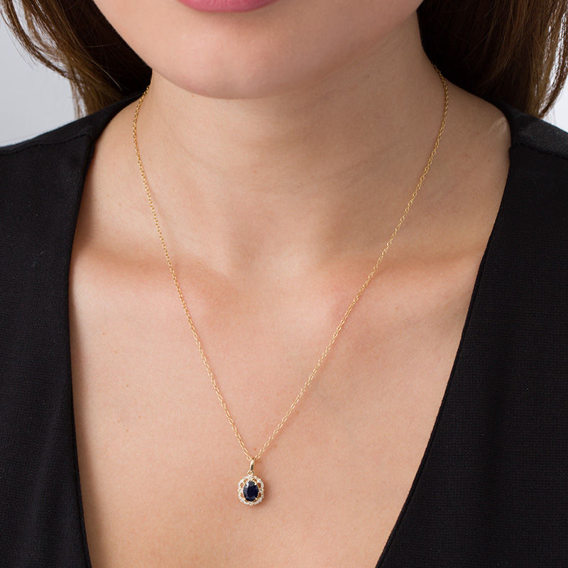 Main Image 2 of Oval Blue Sapphire and 1/6 CT. T.W. Diamond Frame Vintage-Style Pendant in 10K Gold